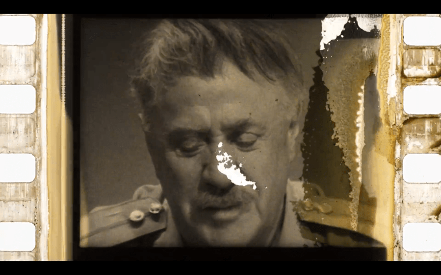 black and white film strip with close up of man's mustachioed face