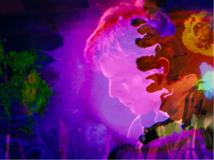 musician David Bowie in profile, framed through pink, red, and green color effects