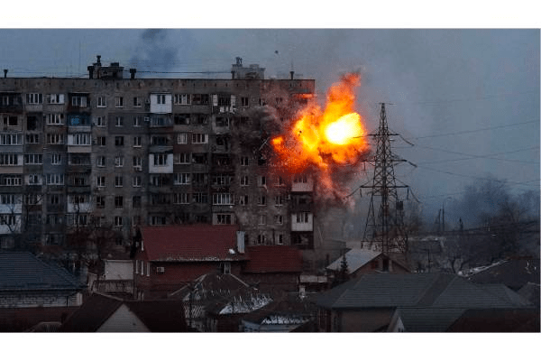 A bomb explodes against a large residential apartment building in Mariupol, a large Ukranian city