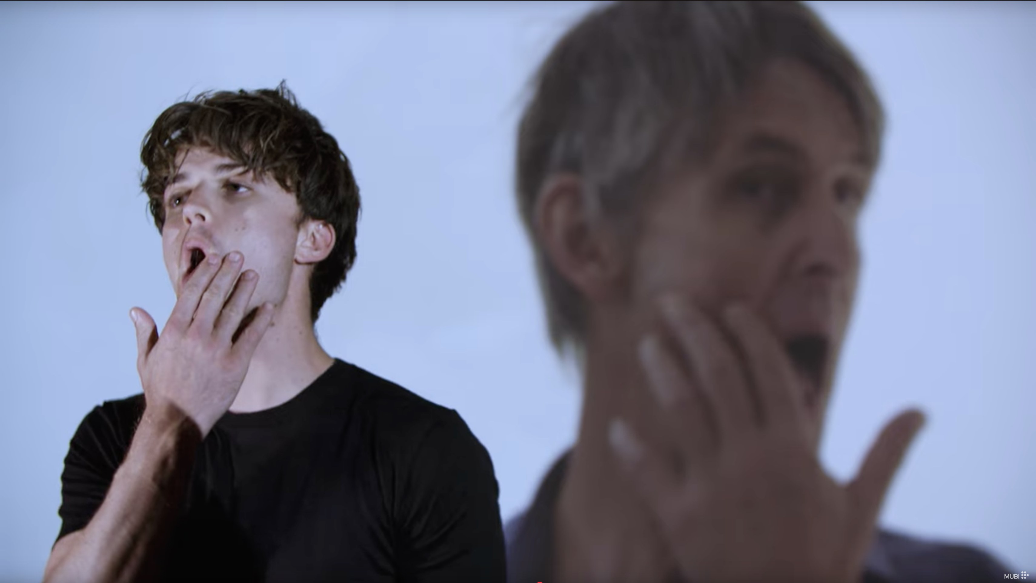 An actor named Joe Keery mimics the gesture of Stephen Malkmus, the lead singer of Pavement, with a mirror reverse shot of putting his hand to his face